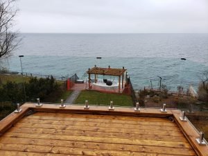 Frameless glass railings for decks installation by Belka Glass, providing a clear lakefront view and enhancing outdoor space with a modern, elegant design in Toronto.