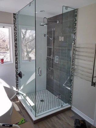 Frameless corner glass shower in a newly renovated home in Toronto