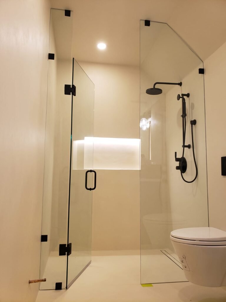 In Line Glass Shower and Glass Door with black shower hardware in Toronto