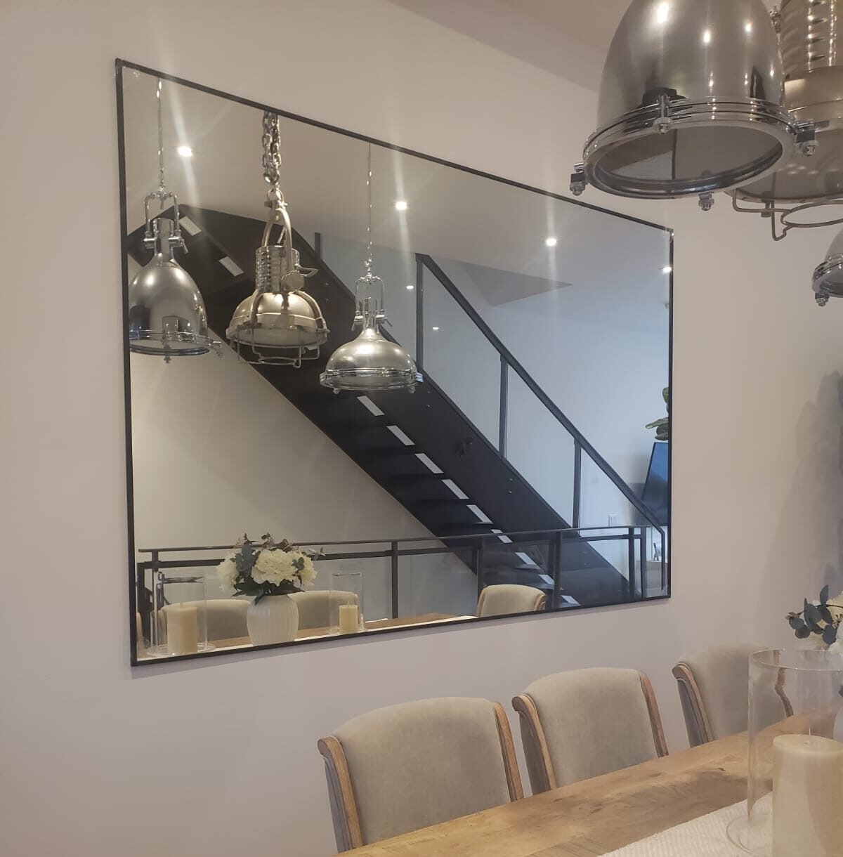 Custom Mirrors in Toronto. Installed in a modern design dining room, featuring luxury furniture and aesthetic lamps.