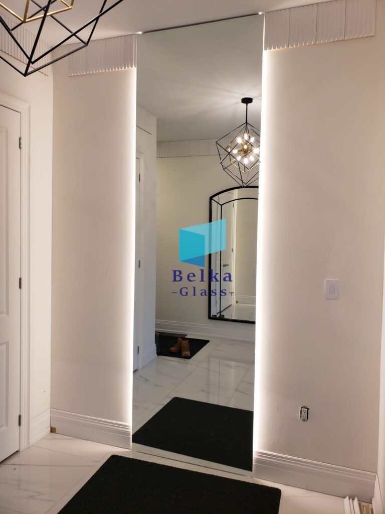 Custom oversized entryway mirror with LED lights by Belka Glass in Toronto. Sleek, modern frameless mirror enhancing space and natural light in a contemporary home interior.
