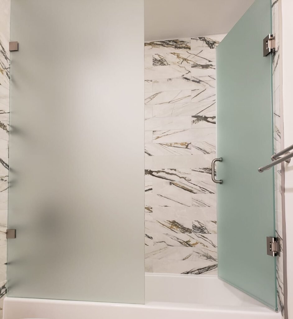 Modern frosted glass bathtub shower doors installed in Toronto by Belka Glass, offering privacy and elegant design