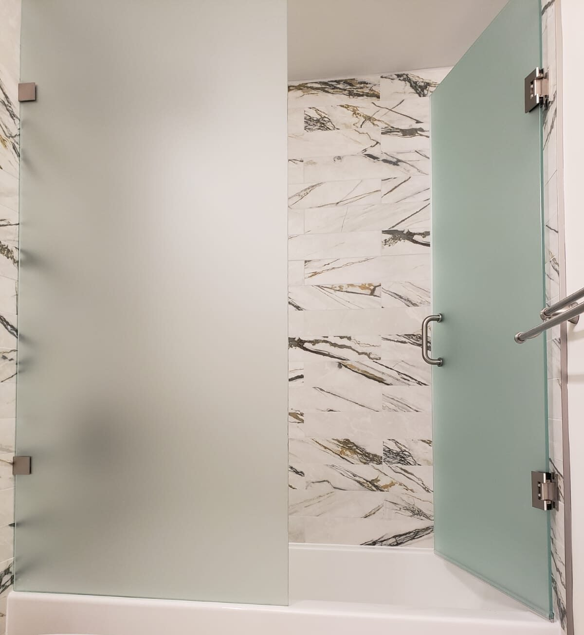 Modern frosted glass bathtub shower doors installed in Toronto by Belka Glass, offering privacy and elegant design
